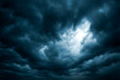 © thodonal - Dark and moody storm clouds with a glimpse of light