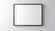 © Wndyy - A sleek black picture frame hanging on a pristine white wall, offering a clean, empty canvas for your artwork, photos, or design concepts. Ideal for mockups and interior decor