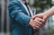 © deagreez - Close-up of a professional business handshake outdoors, symbolizing trust, partnership, and successful collaboration