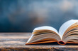 © Phuwadon - An open book resting on a wooden table with a blurred background, inviting readers to explore its stories and knowledge.