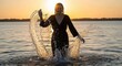 © Tetiana - Young female enjoying sunset in water with dramatic splash