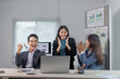 © Crystal - Happy businesspeople celebrating a successful project, clapping hands and looking at laptop screen
