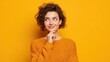 © Johannes - beautiful glad woman smiles tenderly looks away with happy expression thinks about pleasant things wears casual soft jumper isolated over yellow background blank copy space for your promotion no logo