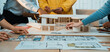 © InfiniteFlow - A dynamic scene of a collaborative design process featuring hands engaged with an architectural model and sketches, showcasing creativity and teamwork in a modern workspace. SACTR