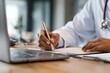 © VolumeThings - A doctor utilizes a laptop to document patient details for diagnosis in a contemporary hospital emphasizing emergency care and health services