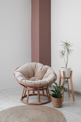 Poster - comfortable armchair and houseplants near white wall in room