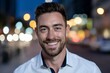 © Rifqi - Close-up portrait of a smiling man with beard in a white shirt at night with bokeh background. Concept for urban lifestyle, professional headshot and dating profile picture