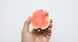 © Ali - Person Holding Half-Eaten Guava Isolated