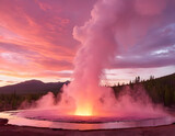 Geyser eruption in a national park, pink clouds in the background at sunset. Grand Prismatic Spring.