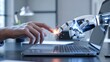 © Design Stock - Close up of a human hand and a robotic hand touching a laptop screen in a modern office setting symbolizing future technology and collaboration