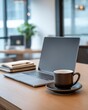 © Ahmad Karim - Closeup of a laptop with a cup of coffee on a wooden table, suggesting a productive work session