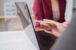 © MINAE - Close-up of hands holding stylus pen pointing at laptop screen, analyzing financial data on spreadsheet, working together on business project
