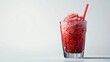 © backup_studio - Red fruit slushy drink with a straw in a glass. Cold summer beverage with ice and fruit for refreshment.