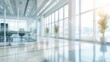 © backup_studio - Blurred office interior background. Empty light open space office with big windows, many glasses walls, desks, chairs and green plants. Modern indoor business environment