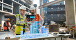 © Gorodenkoff - Female and Male Architects Using Augmented Reality Software on a Tablet Computer to Visualize and Plan a Construction Project. Holographic Interface Displays a Detailed 3D Model of the Building Site