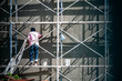 © cookiecutter - Worker Painting Wall on Scaffolding Support