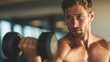 © AI Images - Young muscular man lifting dumbbell during workout in gym with intense focus.