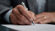 © Vika art - Businessman putting signature on agreement paper.
