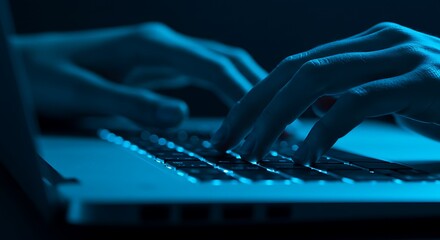 Close-up of hands typing on a laptop keyboard illuminated by blue light, suggesting coding or digital work.
