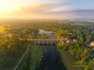 Wall Mural - OLd brick bridge over river in the morning light from above