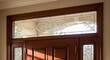 © Tams - Elegant entryway featuring etched glass transom above a wooden door