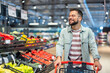 © Dragana Gordic - Smiling Man Shopping in Supermarket Pushing Cart Near Fresh Produce Section