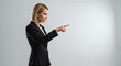 © Tamaras Pictures 4U - Businesswoman pointing while giving direction in a corporate setting