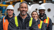 © Maksym - Diverse team of factory workers pose proudly in front of giant finished paper rolls stacked in industrial setting, symbolizing teamwork and production success