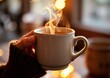 © joeycheung - A cozy hand holds a steaming warm mug, filled with a comforting beverage, against a softly blurred background with golden lights.