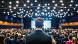 © afridwi - Man on stage facing audience in auditorium