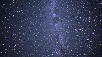 Wall Mural - a mesmerizing video of the night sky filled with stars, captured from a low-angle view, showcasing t