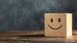 © afridwi - Wooden cube with smiley face on table