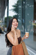 © PaeGAG - Happy shopper talking on phone and holding shopping bags and coffee