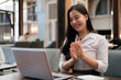 © PaeGAG - Businesswoman clapping hands during a video call in a coworking space
