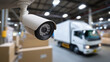 © Curioso.Photography - Surveillance bullet camera monitoring logistics warehouse with delivery truck in background.