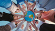 © Довидович Михаил - Group of school friends holding a globe, symbolizing global unity and care for the environment, promoting sustainability and responsibility towards earth