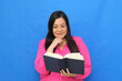 © Arlette - 40-year-old Latina woman with a book in her hands to read, learn, and gain knowledge