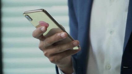 closeup typing text message browsing scrolling smartphone of attractive African american man using app Indoor