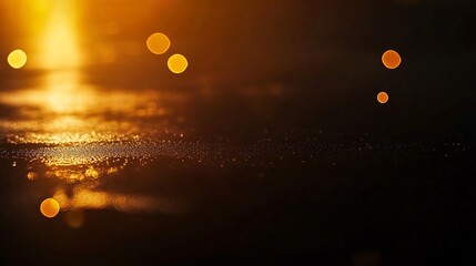 Wall Mural - Abstract blurry golden light reflections on a dark surface with bokeh effect.