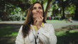 © Krakenimages.com - Woman doctor in uniform with stethoscope pondering outdoors in a park with lush green surroundings showcasing a thoughtful expression