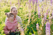 © Iryna - Woman and girl with Down syndrome painting outdoors in lupine field