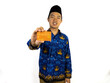© Reynaldi - A happy Indonesian civil servant stands holding an orange card and a cell phone.