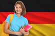 © New Africa - Student with backpack and notebook against flag of Germany. Language school