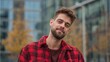 © Serhii - Confident Young Man in Chequered Red Shirt Posing Outdoors in Autumn Cityscape