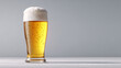 © zuriya - single frosty beer glass with rich golden ale and thick foam cap, on light grey background, crisp cold detail, minimalist autumn beverage with negative space