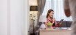© David - Thai asian young working professional female working on laptop at home wears smart formals