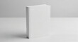 © Airwj - A minimalist shot of a plain white blank book standing upright on a clean white surface against a light grey background.
