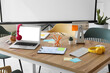 © Pixel-Shot - Table with blank laptop, headphones and sticky notes prepared for business meeting in conference hall