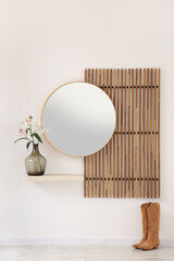 Poster - interior of modern hallway with folding screen, mirror, boots and lily flowers in vase on shelf near