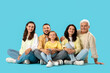 © Pixel-Shot - Portrait of big family sitting on blue background